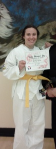 A disheveled me getting my yellow belt. Disheveled, but still victorious.